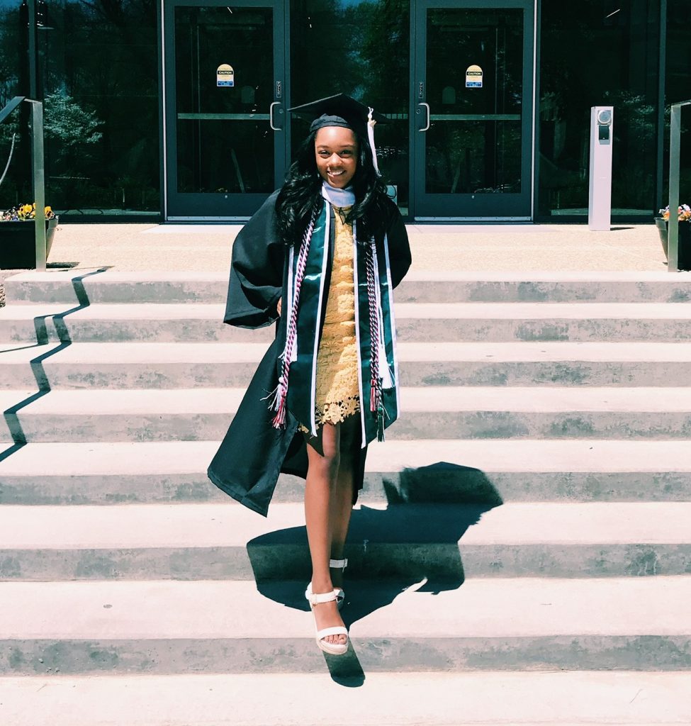 Woman smiling in graduation attire.